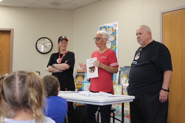 At the Shawnee Public Library on April 27, Red Cross Disaster Program Manager Sherry Schauer and volunteers Becky Miller and Ray Schachner speak to about eight children and their parents on being prepared for a tornado. For the Red Cross Pillowcase Project, the children could decorate a pillowcase and put emergency supplies (some included) and other items they wish to take with them inside. Countywide &amp; Sun/Natasha Dunagan