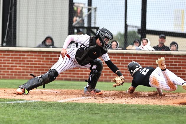 North Rock Creek's Braden Ueltzen tags the Perkins runner out at home.