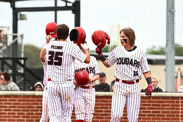 North Rock Creek's Jesse Todd, Jaxon Murray, and Drake Clemmons celebrates Jace Plumb's HR.