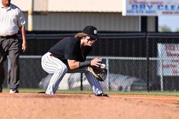 North Rock Creek senior Jesse Todd fields the ball for the out at 1st.