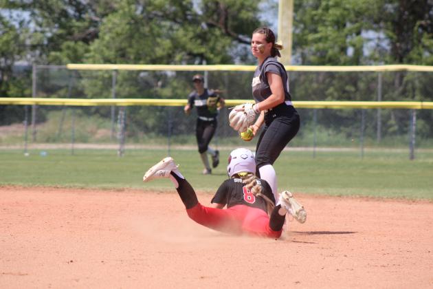 North Rock Creek's Aubree Shivelhood dives into second base, as Tecumseh's Katie Overstreet prepares to throw to the pitcher during the Class 5A Slow Pitch State Semifinals on April 30. The #1-ranked Lady Cougars won in their Quarterfinals with Perkins-Tryon, 10-9, but lost to the #2-ranked Lady Savages in the Semifinals, 7-13. Their record this season is 33-9. Countywide &amp; Sun/Natasha Dunagan