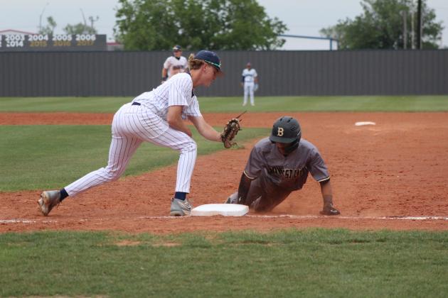 Shawnee freshman Rhett Hokit makes the catch and tries to tag the Midwest City runner, who dives. back to first, during the home game on April 25. The Wolves lost, 1-8. Countywide &amp; Sun/Natasha Dunagan