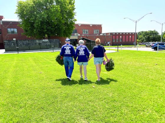 David and Linda Hendrickson and Donna Beth Warren walk in unity to the Gold Star monument at Woodland Veterans Park in Shawnee. The morning was filled with a lot of emotion from the families and those who attended the service. Countywide &amp; Sun/Suzie Campbell
