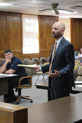 Jordan Smith with Stephen L. Smith Corp. speaks to the Shawnee Board of Education before reading bank bids for a construction bond sale.