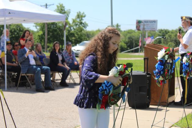 Sarah Jett, daughter of State Senator Shane Jett, places a wreath during the Memorial Day service at Tecumseh Cemetery on May 27. Wreaths were placed for each military branch plus the emergency responders, and an 18-gun salute was given. Rev. Paul Fletcher, with Northridge Church of Christ in Shawnee, and State Senator Shane Jett spoke, as well as Post Adjutant Bill Gammage. Countywide &amp; Sun/Natasha Dunagan