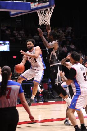 Potawatomi Fire Point Guard Deshawn Munson makes a jump pass to Isaiah Wade who made the bucket in the second game of the Central Conference Semifinals with the Wichita Skykings. Munson broke his own record by sinking 25 rebounds in this game.