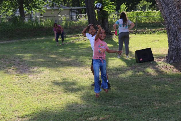 Norah Lightfoot, 6, throws a ball, as her brother, Zaire Lightfoot, 9, watches during a game of catch at the Juneteenth Celebration held behind the Epicurean Delight (Epic Sno Cones) stand on June 19. In addition to games of catch, horseshoes and checkers, business owner David Henry spoke about the history of Juneteenth and posed some trivia questions. Henry said it is a time of reflection and remembrance, and he suggested voting as a way to celebrate Juneteenth "for all the people who couldn't vote."