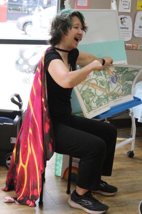 Kim Zahller, a librarian at the Norman Pioneer Systems Library, dressed as a butterfly and read "I Love Spiders" for Shawnee Library's First Annual Bugfest on June 1. She also read "In the Tall, Tall Grass" for a large group of children. during Bugfest on June 1. In addition to story time, the event offered a honey tasting, crafts, and OSU's Insect Adventure. Countywide &amp; Sun/Natasha Dunagan