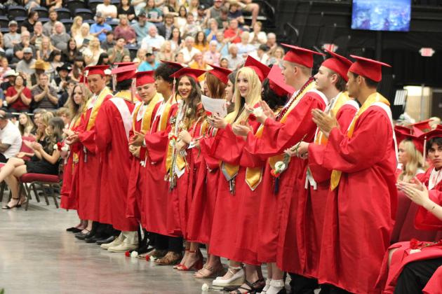 Fourteen valedictorians stand to be recognized at the McLoud graduation on May 18. Out of them, 10 spoke at the event, which was held at FireLake Arena. McLoud gradutated 120 seniors this year. Countywide &amp; Sun/Natasha Dunagan