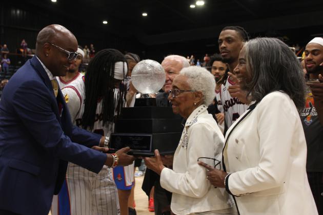 "The Lillie" TBL National Championship Trophy namesake Lillie Mae Greer and her daughter TBL CEO Evelyn Magley present the trophy to the Potawatomi Fire - including K.D. Moore, second from left, and  Ricky Artis II, fifth from left - and Citizen Potawatomi Nation Chairman John "Rocky" Barrett. This was done in honor of Greer's late husband, who passed recently. The Fire was the first TBL team to be owned by a Native American tribe (the CPN), &amp; they are also the first TBL team to win back-to-back nationals.