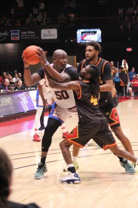 Potawatomi Fire Forward/Center Paul Harrison tries to defend the ball and look to pass, despite the St. Louis Griffins aggressive defense, in the fourth quarter of The Basketball League National Finals at FireLake Arena on June 23. They topped off their undefeated third season by beating the St. Louis Griffins, 119-108, becoming the first TBL team to win back-to-back national titles. Countywide &amp; Sun/Natasha Dunagan