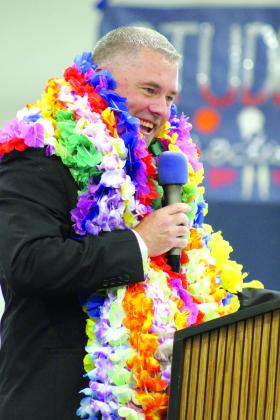 Asher High School Principal Steve Spangler announces the Class of 2024 after they received their diplomas and presented Spangler with leis at graduation on May 11. Countywide &amp; Sun/Natasha Dunagan