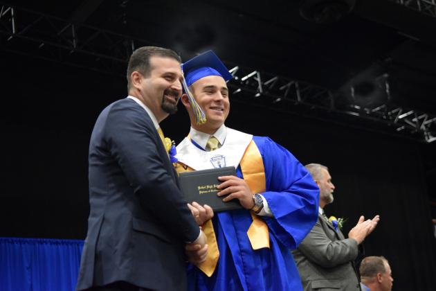 Bethel graduate, Bray Bussell, receives his diploma on May 18th from father, Brandon, who is a Bethel school board member.  Countywide &amp; Sun/Julie Talton