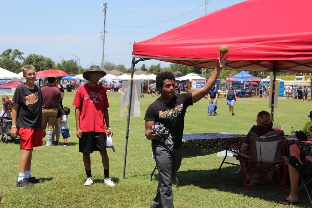 Kadin King, of McLoud, tries his hand at dunking Youth Football Coordinator Jonathan Raper during the McLoud Blackberry Festival on July 13. Proceeds went to the Youth Football and Cheer programs. Countywide &amp; Sun/Natasha Dunagan