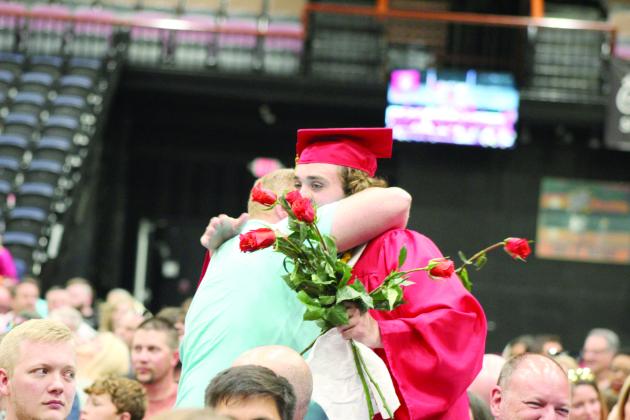 Dale Graduate Deken Jones gives a rose and a hug to Girls Basketball Coach Scott Wilson during graduation on May 13. Countywide &amp; Sun/Natasha Dunagan