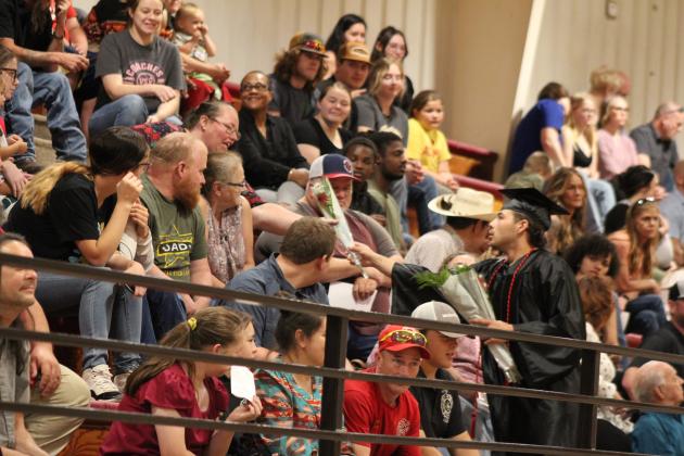 Earlsboro Graduate James Smith, Jr. shares flowers during graduation on May 10. Countywide &amp; Sun/Natasha Dunagan
