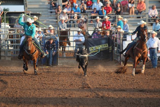 Damian Padilla, of Rio Rico, AZ, and Lil Calmelat, of Tucson, AZ, compete in the team roping event of the International Finals Youth Rodeo on the night of July 12. Countywide &amp; Sun/Natasha Dunagan