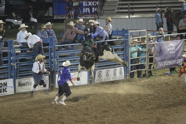 Jack Mitchell, of Weatherford, TX, hangs on as his bull seems to fly on the night of July 12 at the International Finals Youth Rodeo, held at the Heart of Oklahoma Expo Center. Mitchell was the bull riding champion this year. Countywide &amp; Sun/Natasha Dunagan
