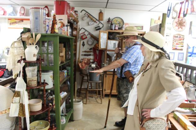 Mickey Davis talks with Tecumseh Historical Society Volunteer Arthenia Haney about kitchen tins during the Tecumseh Pioneer Library's "In My Experience: Tecumseh History" tour on July 16. The library will have a "Party at the Park - Summer Learning Challenge Celebration" for children and teens today (July 25) at Slick Humphrey Park from 2-3 pm. Countywide &amp; Sun/Natasha Dunagan