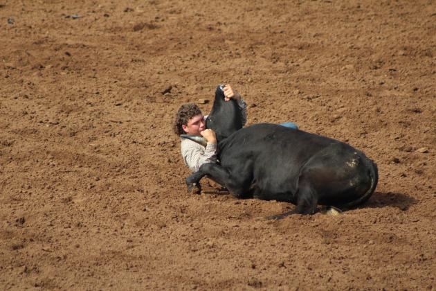 Dally Trussell, of McLoud, wrestles his bull.