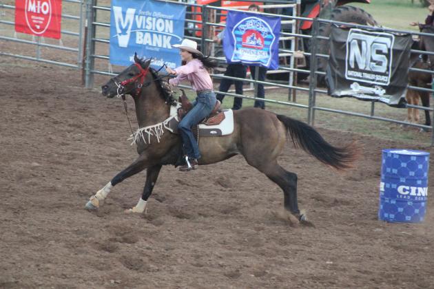 Sadie Walker, of Shawnee, rides between barrels one and two on the evening of July 9 at the International Finals Youth Rodeo, held at the Heart of Oklahoma Expo Center. Countywide &amp; Sun/Natasha Dunagan