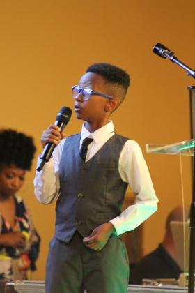 Sammy "Trey" Wallace, 9, of OKC, reads the second book he's written, "The No Sleep Curse," at the Juneteenth Reception, held at the Grand Casino Hotel and Resort on June 21. Wallace wrote his first book, "I Slept in My Bed Last Night," when he was five and had it was published at age 7, said his father, Sammy Wallace Jr. T. Wallace is the nephew of Gloria Wallace, of Shawnee. Countywide &amp; Sun/Natasha Dunagan