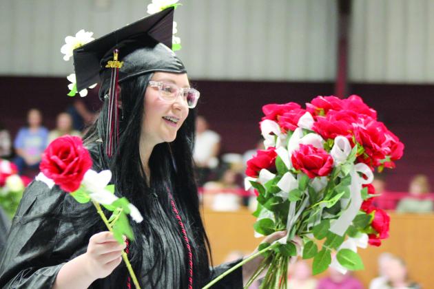 Macomb Graduate Hailey Bridgeford delivers flowers at graduation on May 4. Countywide &amp; Sun/Natasha Dunagan