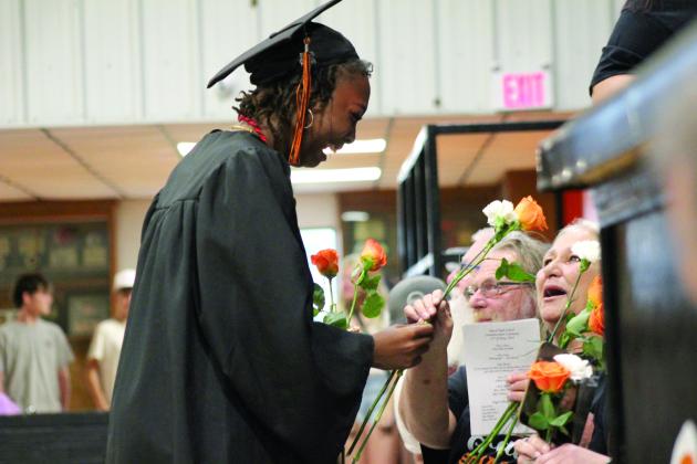 Maud Graduate Kamile Jones has an emotional moment while handing out flowers at graduation on May 17. Countywide &amp; Sun/Natasha Dunagan