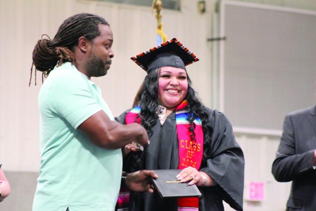 Maud Coach Royce Street presents Genesis Thorpe with her diploma at the Commencement Ceremony on May 17. Thorpe requested that Coach Street be the one to give her diploma. Countywide &amp; Sun/Natasha Dunagan