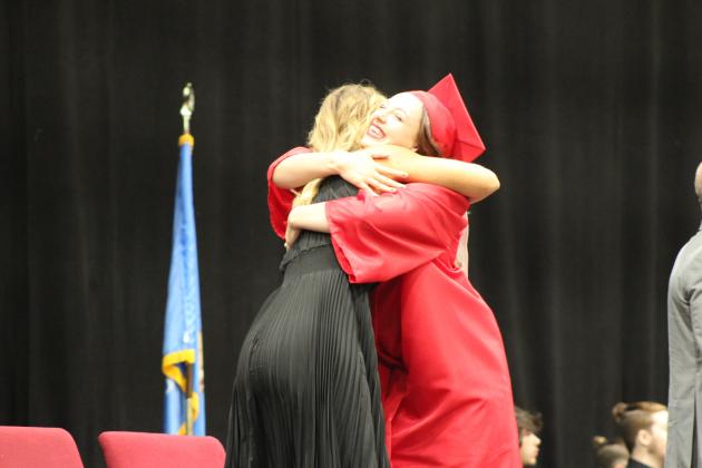 McLoud Superintendent Rhonda Hockenbury gives Graduate Paisley Erskine a hug during graduation at FireLake Arena on May 18. Countywide &amp; Sun/Natasha Dunagan