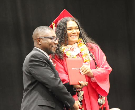 McLoud Graduate Breanna (Dani) Banks gets her diploma from School Board Member Shelton Mapira at FireLake Arena on May 18. Countywide &amp; Sun/Natasha Dunagan