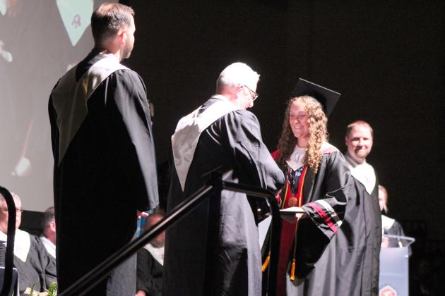 North Rock Creek Graduate Haley Hacker receives her diploma from Co-Principal Chad Brooking during graduation on May 16. NRC had 101 graduates this year. Countywide &amp; Sun/Natasha Dunagan