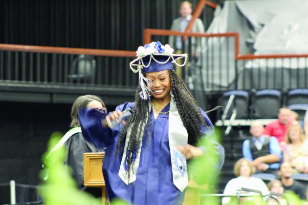 Shawnee Graduate Trinity Shirley dances across the stage to accept her diploma during the 126th Shawnee High School Commencement Ceremony on May 16 at FireLake Arena. Countywide &amp; Sun/Natasha Dunagan