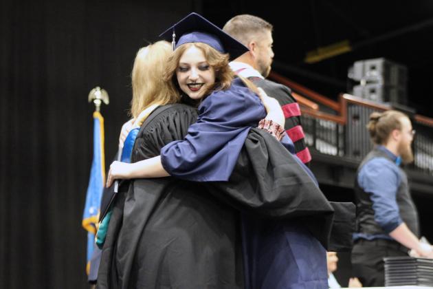 Shawnee Graduate Megan Herd gives a hug to retiring Alternative Education Director Deborah Watson during the 126th Shawnee High School Commencement Ceremony on May 16 at FireLake Arena. Countywide &amp; Sun/Natasha Dunagan