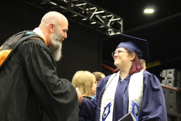 Shawnee Graduate Makayla Anderson shakes hands with SHS Principal Matt Johnson after receiving her diploma during the 126th Shawnee High School Commencement Ceremony on May 16 at FireLake Arena. Countywide &amp; Sun/Natasha Dunagan
