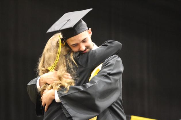 Tecumseh Graduate Levi Bingham gives his grandmother Iva Bingham, also a school board member, a hug at graduation on May 21. Countywide &amp; Sun/Natasha Dunagan