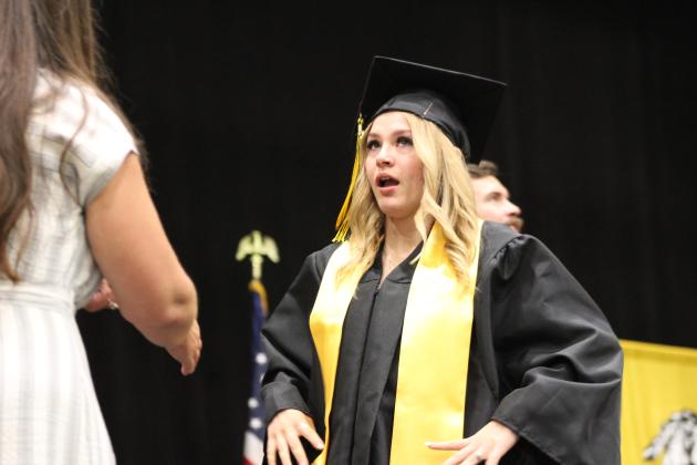 Tecumseh Graduate Hannah Hudson collects herself before receiving her diploma from School Board Member Nicole Sanchez at graduation on May 21. Tecumseh graduated 135 seniors this year. Countywide &amp; Sun/Natasha Dunagan