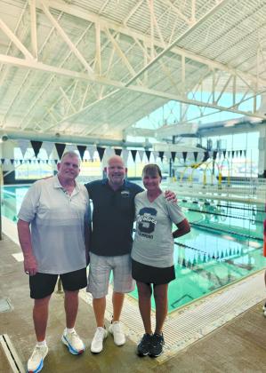 Shawnee High School Assistant Swim Coach and YMCA Interim CEO Bob McNeil, Shawnee Public Schools Athletic Director Dax Leone and SHS Head Swim Coach Valarie Colburn pose together by the newly remodeled Shawnee YMCA pool during its Grand Reopening on July 13. Photo provided by Amanda Teape Johnson.