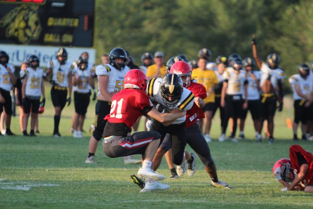Tecumseh junior A.J. Buttram carries the ball as he tries to break out of a tackle by two North Rock Creek players, Easton Murray and Jaxon Murray, at the four-team scrimmage, held at Tecumseh High School on Aug. 23. Besides NRC and THS, Bethel and Bridge Creek participated. The Savages' first home game will be against McLoud on Sept. 20 at 7:30 pm, and it will be homecoming. NRC's first game will be Aug. 30 at 7 pm against Marlow. Countywide &amp; Sun/Natasha Dunagan