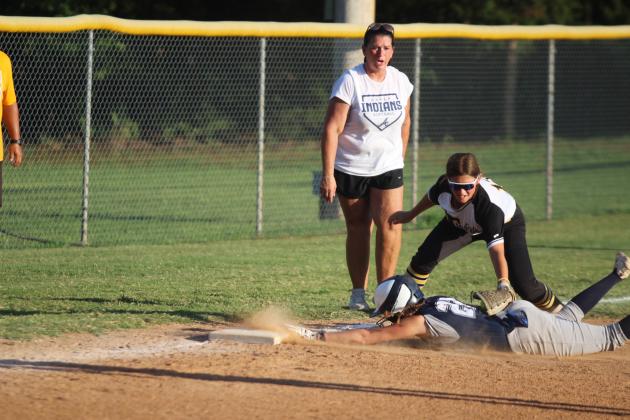 Asher sophomore Makenah Templeton dives and is safe at third base, as a Tupelo player tags her too late and Head Coach Tari Dubler cheers her on, during the second inning of the Aug. 19 home game. The Lady Indians won, 3-1. Countywide &amp; Sun/Natasha Dunagan
