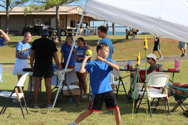 Shane Williams, 12, of Bethel, tries his hand at the Bethel Wrestling Dunk Tank during the Bethel High School Blue &amp; Gold Bash on Aug. 17. Bethel eighth-grader and wrestler Andrew Hartman was in the dunk tank. Countywide &amp; Sun/Natasha Dunagan