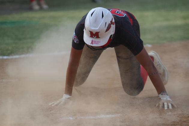 Taycee Lewis dives into home.