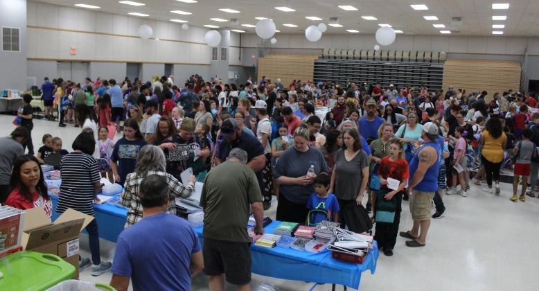 Families and students fill the WP Wood/THS Alumni Center waiting in line at eight stations for school supplies and backpacks on July 27 during the 10th Annual Mission Tecumseh Back to School Bash. Mission Tecumseh Board Member Anthony LaGrange said they gave away the 549 backpacks they had available in the first hour and continued to hand out school supplies until those ran out. Countywide &amp; Sun/ Natasha Dunagan