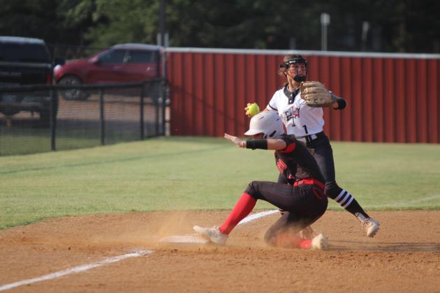 McLoud's Ella Smith slides into third base during the third inning of the home game with Perkins-Tryon on Aug. 26. The Lady Redskins won, 13-6. Countywide &amp; Sun/Natasha Dunagan