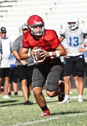 North Rock Creek's (NRC) Landon Kelough looks down field for an open receiver. NRCs football team looks good for the upcoming season. They were in a four-way scrimmage against Bethel, Tecumseh, &amp; Bridge Creek.  NRC will open Aug. 30 at home against Marlow. Photo courtesy of Gowin Photography