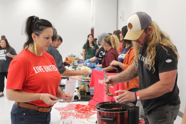 Travis Flood, with Community Renewal, right, dishes up a bowl of chili for Emily Rothrock during the Second Annual United Way Kickoff Cookoff, held at the Gordon Cooper Technology Center Safety Center on Aug. 27. There were 21 entries from non-profits, businesses and churches in the event, said United Way of Eastern Frontier Country Executive Director Sandy Vanderburg. Countywide &amp; Sun/Natasha Dunagan