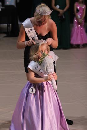 Tot Miss Frontier Days Autumn Hughes smells her roses as 2023 Miss Frontier Days Aleigha McCullough crowns her.