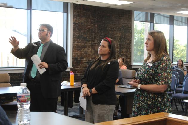 Shawnee Middle School administrators Levi Dobrinski, Jayme Hutchcraft and Keely Tolin speak to the school board about their OPI scores.
