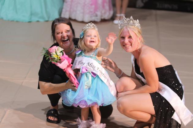 Miller Seikel, age 2, waves to the crowd after being crowned the 2024 Tiny Miss Frontier Days on Sept. 22. The 2023 Miss Frontier Days Aleigha McCullough, right, crowned her. Also shown is her mother. There were nine contestants in the Tiny division, ages 0-3. Countywide &amp; Sun/Natasha Dunagan