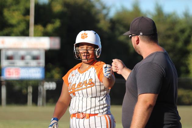 Maud's Amerikus Street gets a fist bump from Assistant Coach Dalton Martin after hitting a single during the home game with Mill Creek on Sept. 16. Countywide &amp; Sun/Natasha Dunagan
